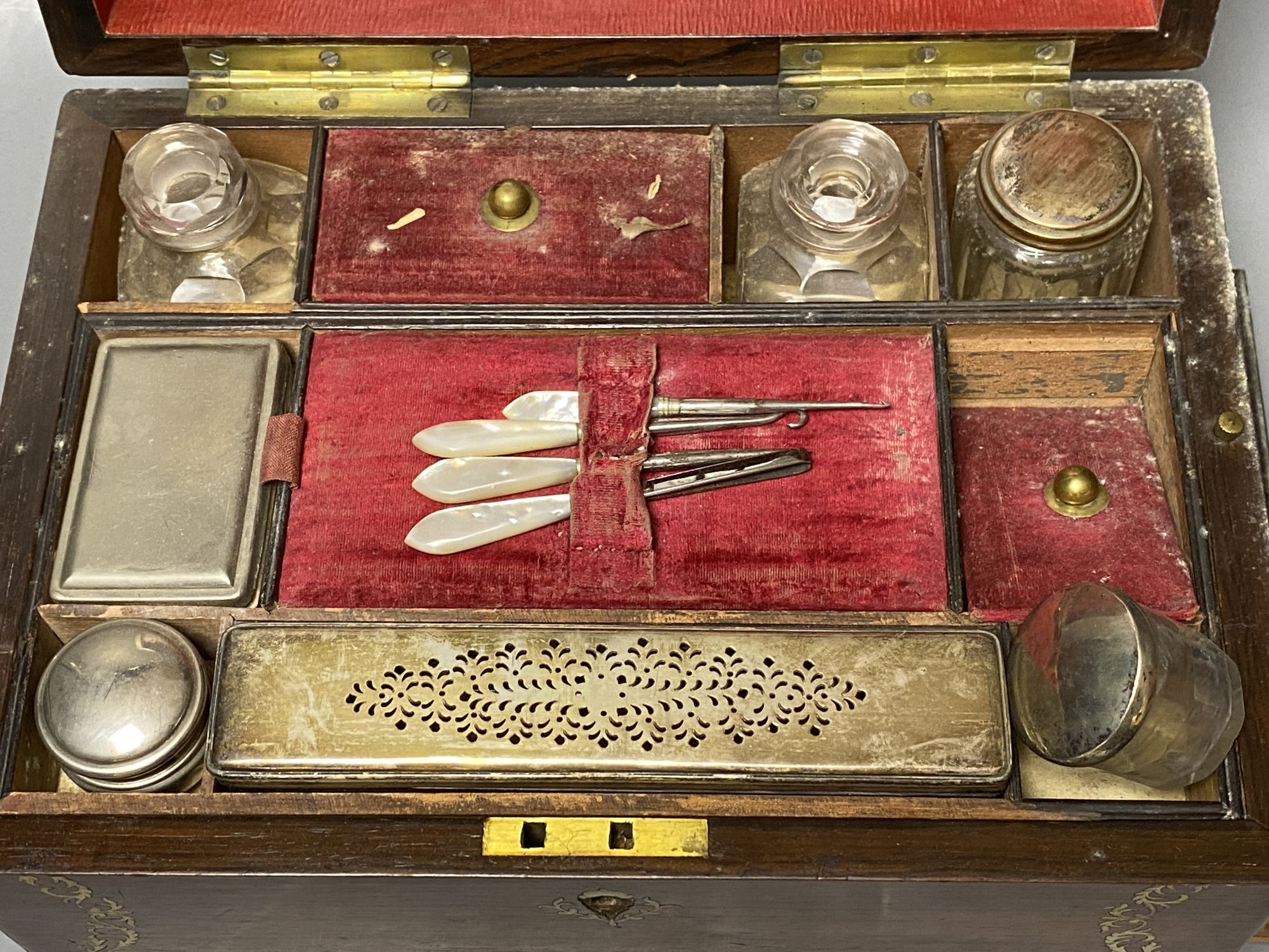 A 19th century mother of pearl inlaid rosewood travelling toilet box